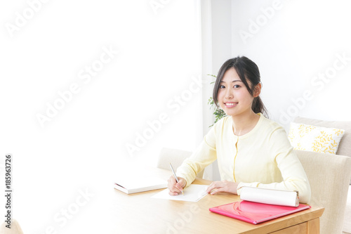 Female student studying for an entrance exam at home