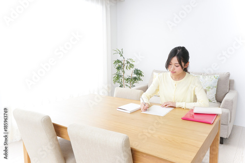 Female student studying for an entrance exam at home