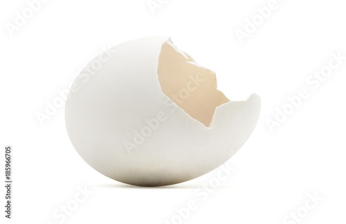 Empty golden cracked egg shell on white.