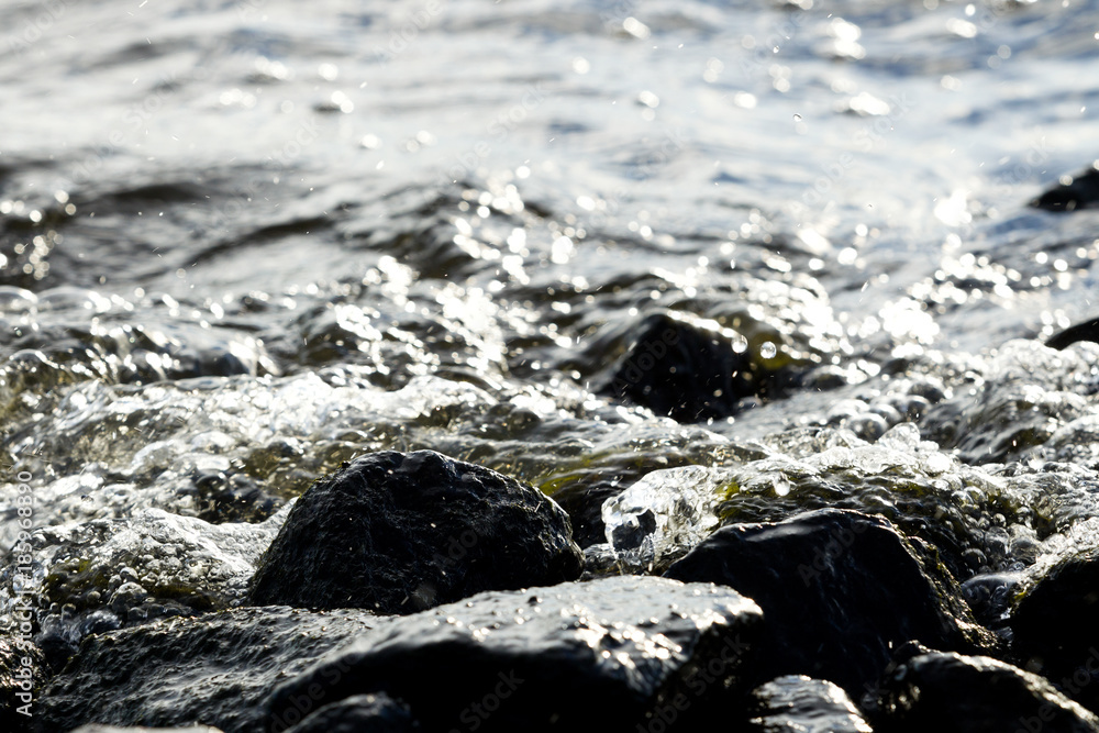 Coastal rocks on wave background Coastal rocks on wave background