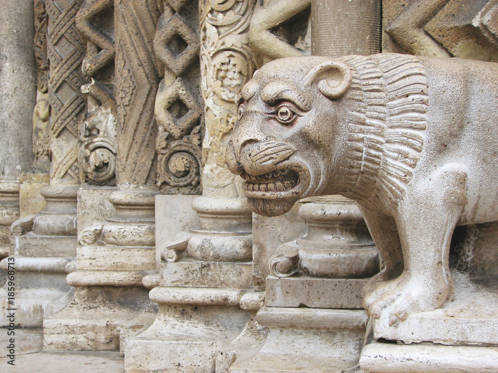 Ancient sculpture of a lion near the entrance to the church. Vajdahunyad Castle, Budapest, Hungary.