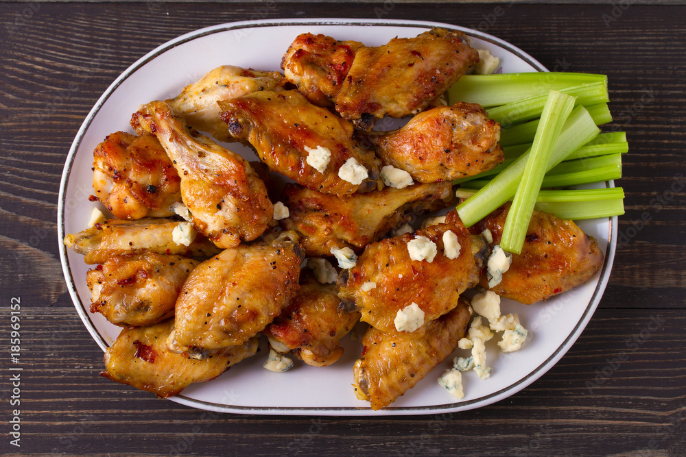 Chicken wings buffalo with blue cheese and celery sticks. View from above, top, horizontal Chicken wings buffalo with blue cheese and celery sticks. View from above, top, horizontal