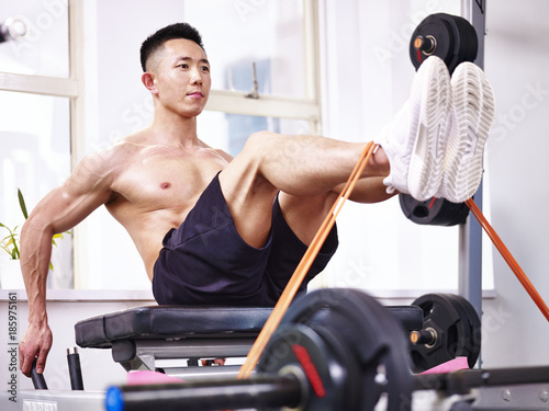 asian bodybuilder exercising in gym photo