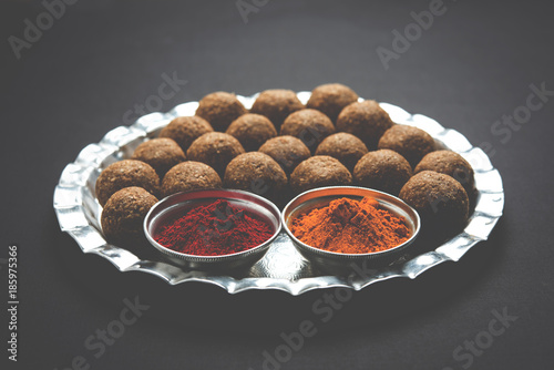 Tilgul or Til Gul with haldi Kumkum and halwa/chiranji or sugar balls for makar sankranti festival
 photo