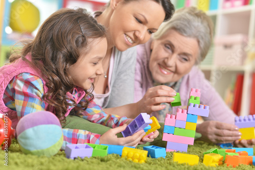 family playing with colorful plastic blocks