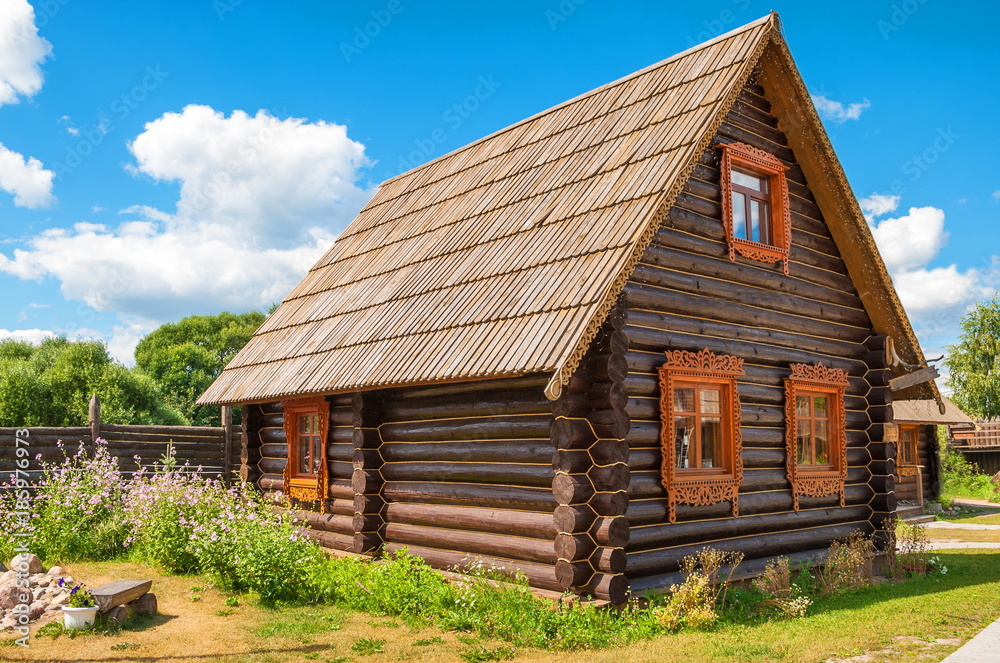 Log house - mansion with carved shutters on the windows Log house - mansion with carved shutters on the windows