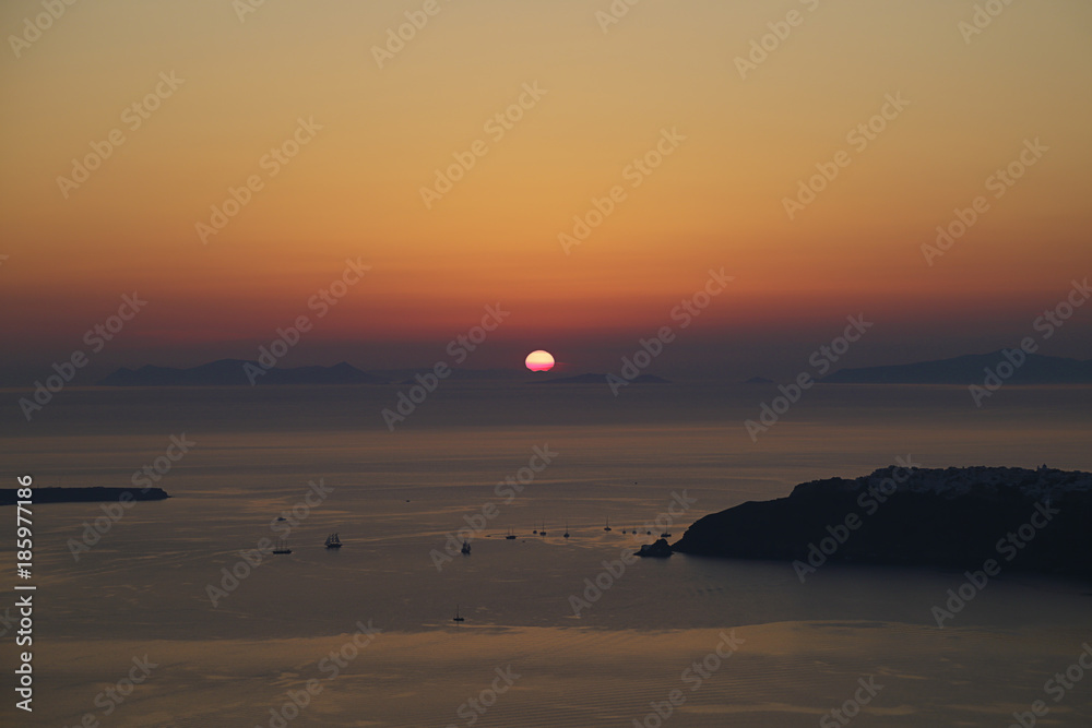 Sunset on Santorini island with some sailboats, Greece Sunset on Santorini island with some sailboats, Greece