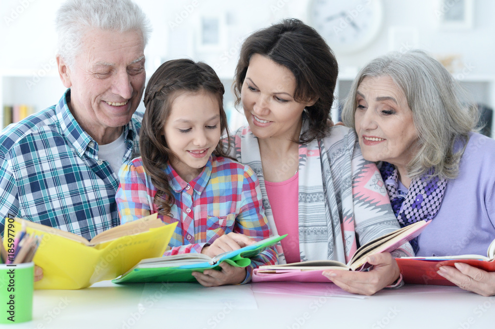 Grandparents with cute little girl doing homework Grandparents with cute little girl doing homework