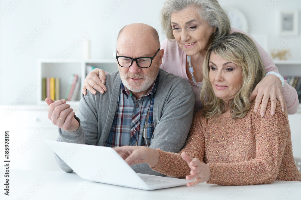 two Senior women and man using laptop two Senior women and man using laptop
