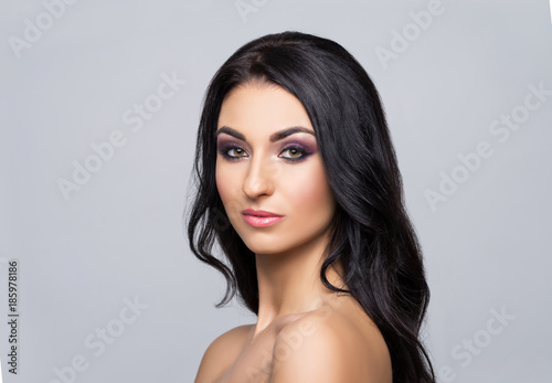 Beauty close-up portrait of beautiful, fresh and healthy girl. Human face over grey background