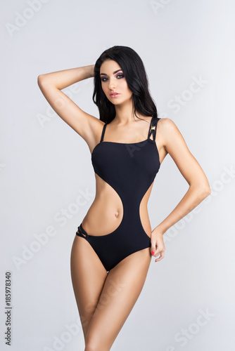 Fit, healthy and sporty woman in swimsuit. Sport, fitness, diet and healthcare concept.