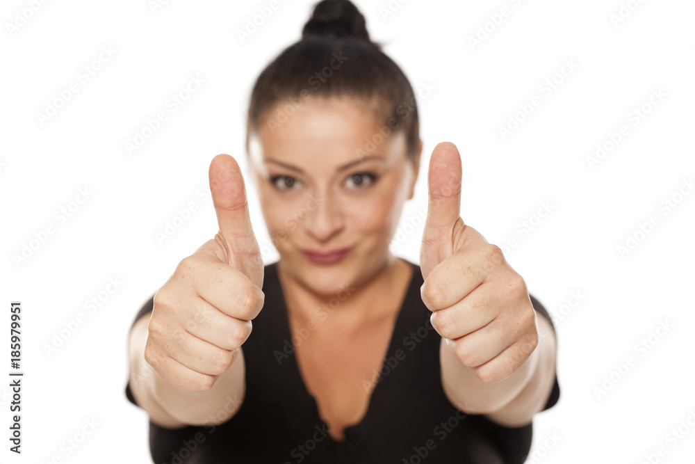 chubby woman shows thumbs up on white background chubby woman shows thumbs up on white background