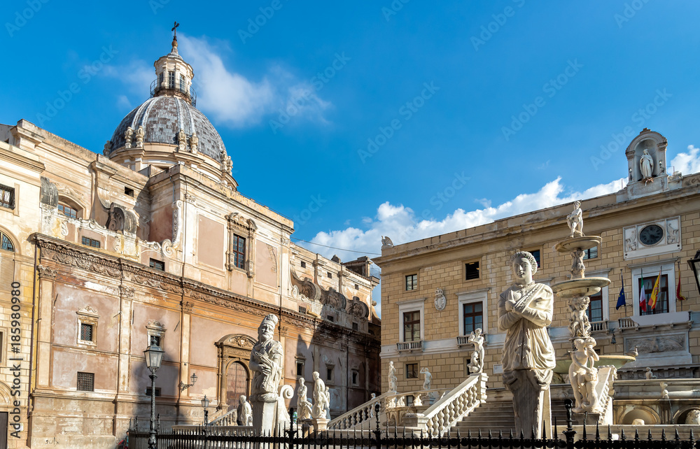 Fototapeta premium View of Santa Caterina church dome with statue of the Pretoria fountain ahead in Palermo, Sicily, Italy