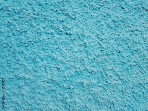 Сoncrete of a blue plastered wall. Sky blue plastered wall texture grunge background. Beautiful decorative light blue plastered wall or cyan painted stucco. Handmade rough winter christmas paper.