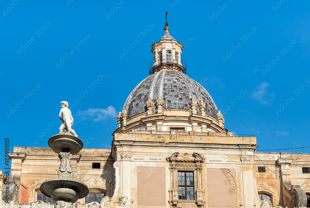 View of Santa Caterina church dome with statue of the Pretoria fountain ahead in Palermo, Sicily, Italy