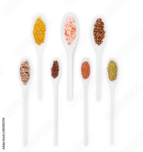 spices in the spoons on a white background. set