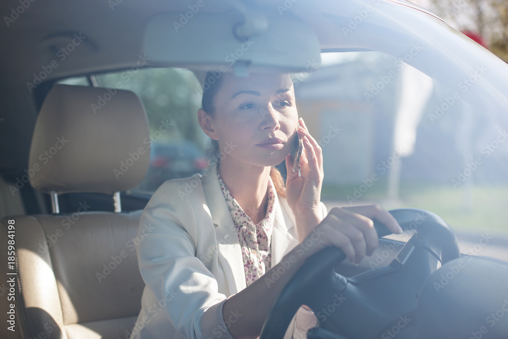 Fototapeta premium woman with a phone in the car.