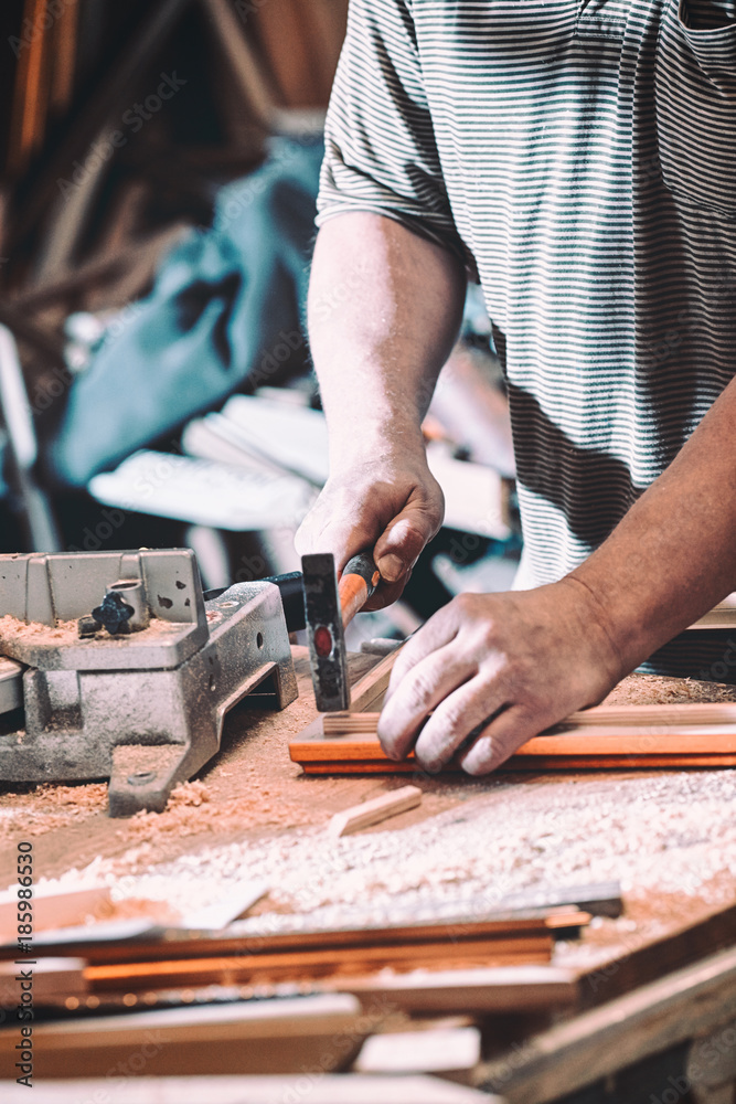 The joiner makes the product frame for the painting. The joiner makes the product frame for the painting.