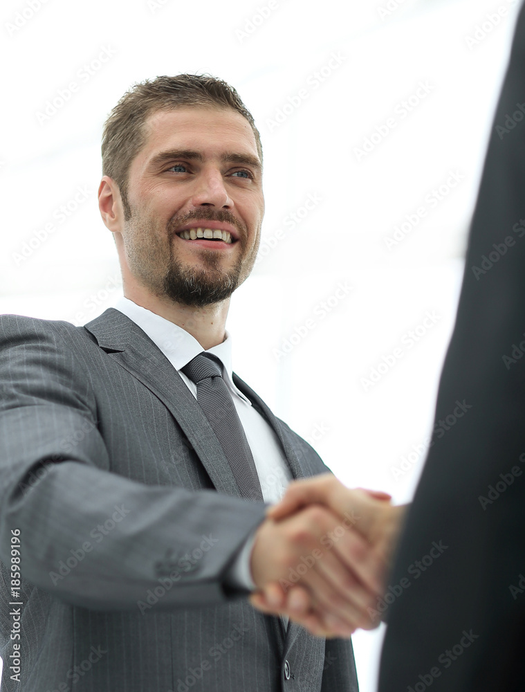 closeup .businessman shaking hands with a business partner. closeup .businessman shaking hands with a business partner.