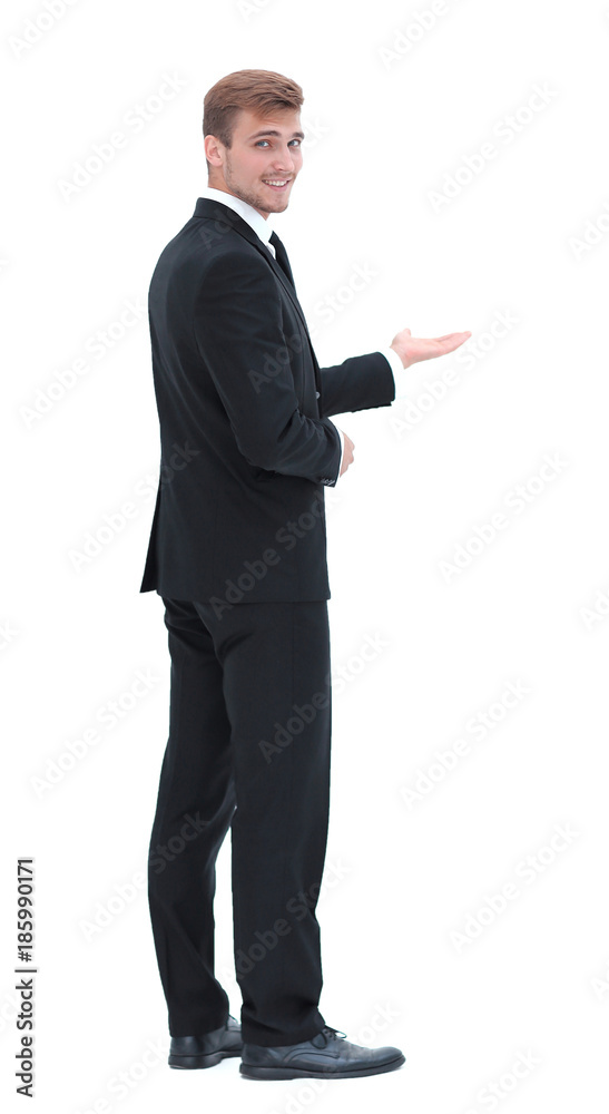 rear view.smiling businessman pointing forward. photo in full growth. rear view.smiling businessman pointing forward. photo in full growth.