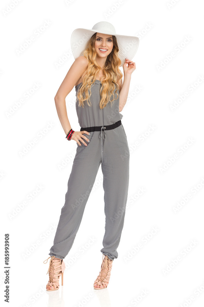 Beautiful Young Woman In Jumpsuit, High Heels And Sun Hat. Beautiful Young Woman In Jumpsuit, High Heels And Sun Hat.