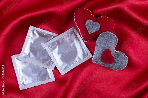 red heart and condom, safe sex, valentine's concept photo