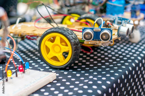 Homemade robot on wheels with eyes. Hobby robotics photo