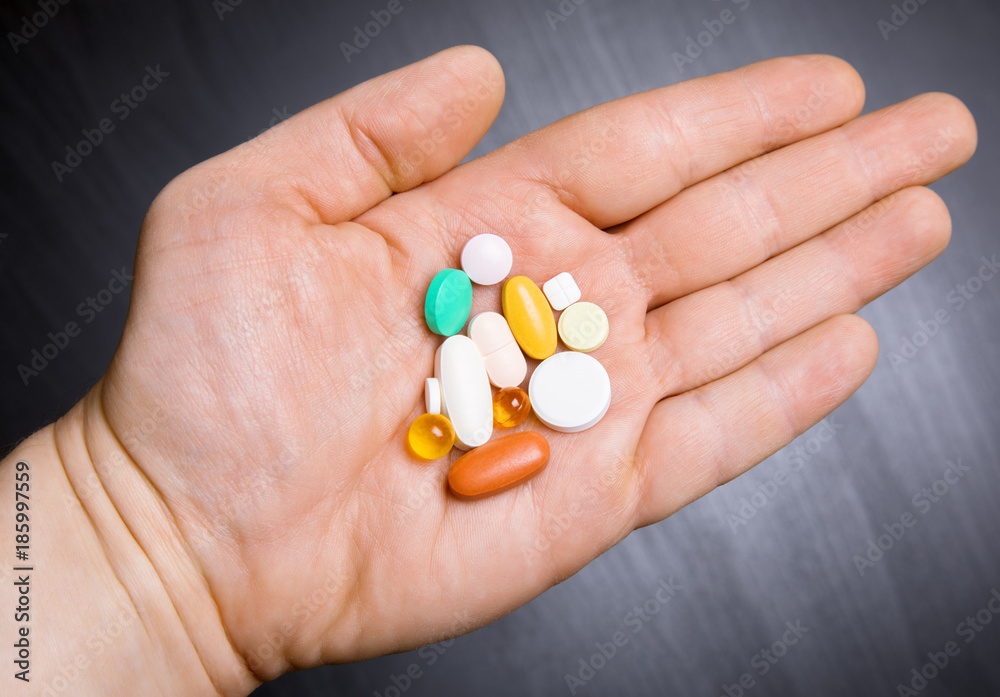 daily dose of pills on the human hand daily dose of pills on the human hand
