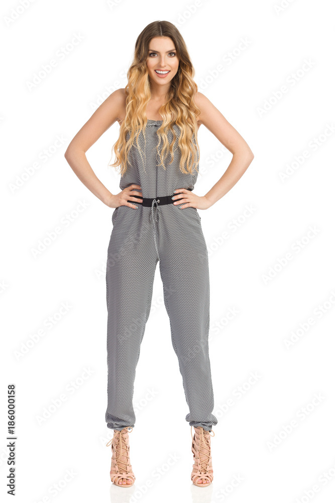 Confident Smiling Fashion Model In Jumpsuit And High Heels Confident Smiling Fashion Model In Jumpsuit And High Heels