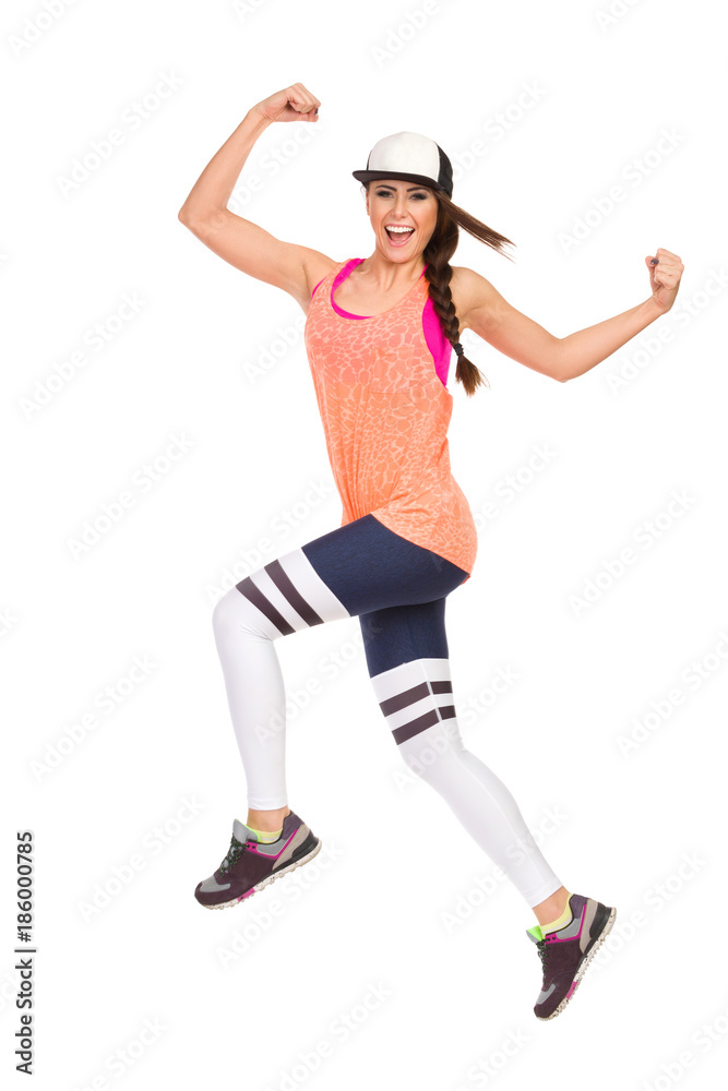 Happy Woman In Sports Clothes Is Jumping And Shouting