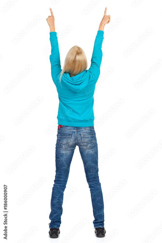 Woman Standing With Arms Raised And Pointing Up. Rear View. Woman Standing With Arms Raised And Pointing Up. Rear View.