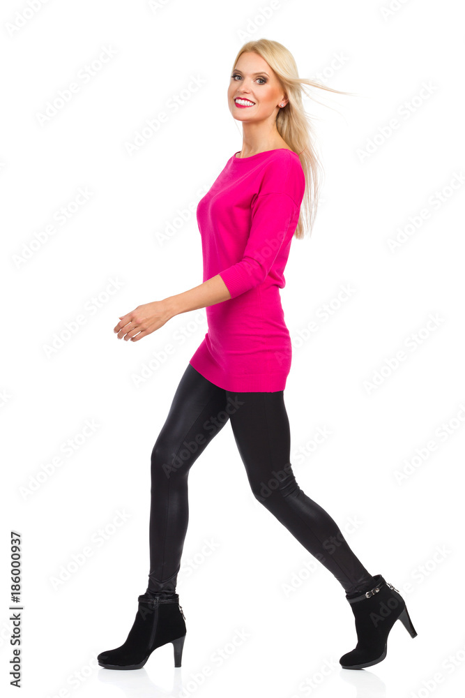Smiling Blond Woman Is Walking And Looking At Camera. Side View. Isolated On White Smiling Blond Woman Is Walking And Looking At Camera. Side View. Isolated On White