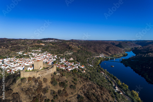 Aerial view of the Belver Castle (Castelo de Belver) and village with the bridge over the Tagus River in the background, in Portugal; Concept for travel in Portugal 
