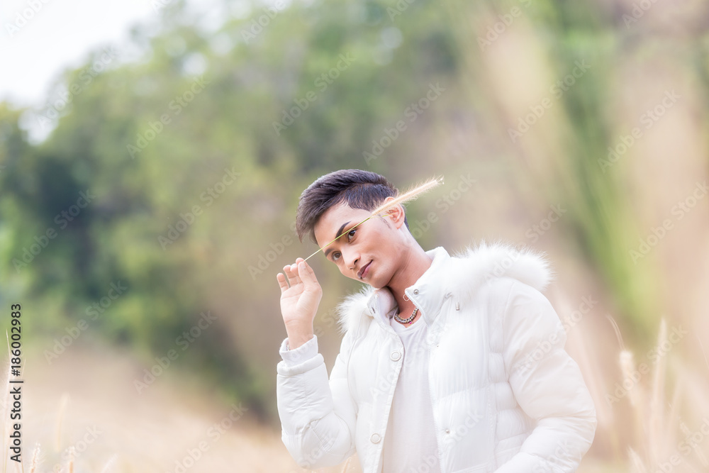 Male model wearing white sweater on the meadow. Male model wearing white sweater on the meadow.