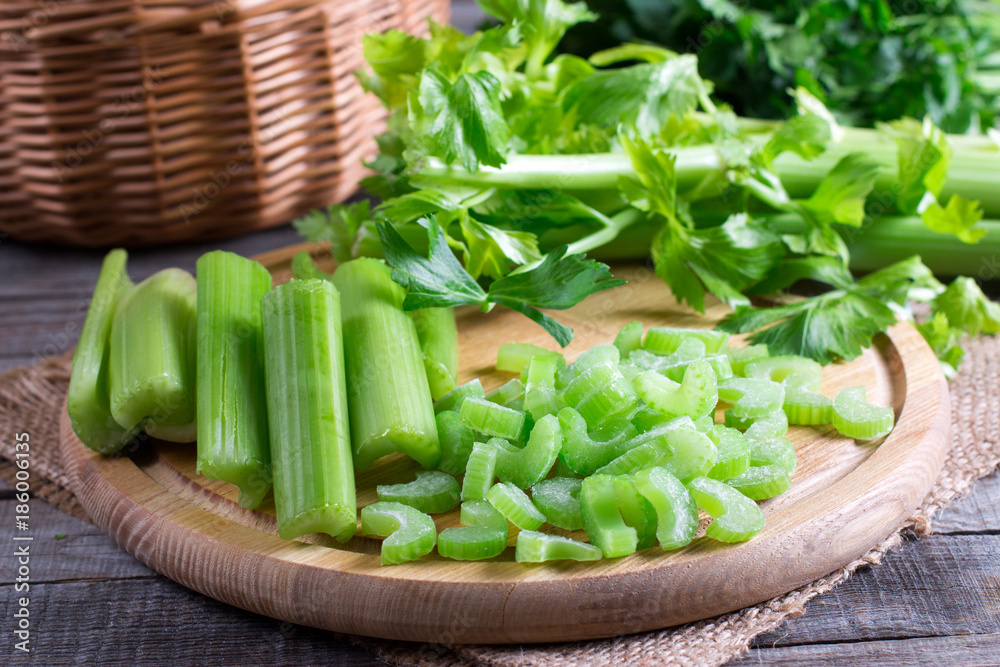 Sliced frozen celery on a cutting wooden board Sliced frozen celery on a cutting wooden board