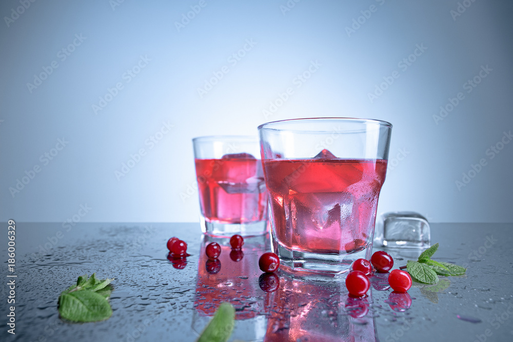 closeup of a cape cod cocktail or vodka cranberry on a blue background closeup of a cape cod cocktail or vodka cranberry on a blue background