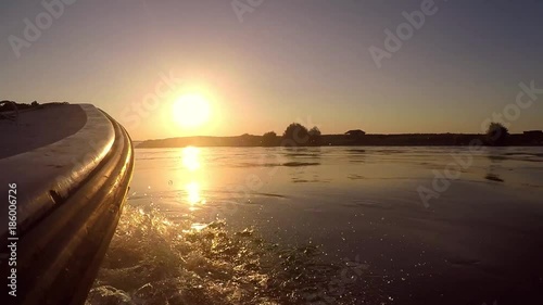 Boat river crossing in sunset.
