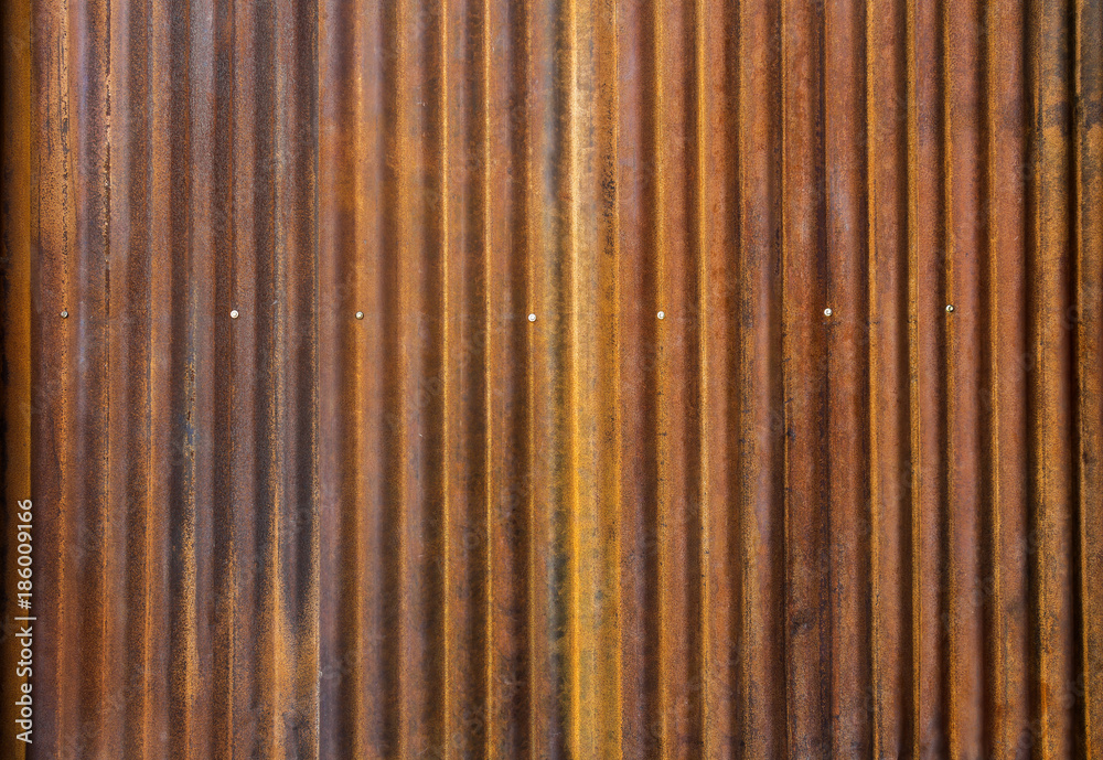 Corrugated zinc fence with old rusty surface brown for the background. Corrugated zinc fence with old rusty surface brown for the background.