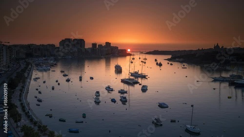 Time lapse of a runrise at marina with boats and buildings in Valletta, Malta. 4K UHD HDR 422 10 bit ProRes  photo