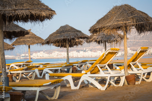 Beach loungers and umbrellas on the sea. Main beach in Agadir city located on the shore of the Atlantic Ocean.Morocco.