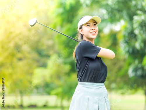 Asian cute woman smiling after end of swinging golf club