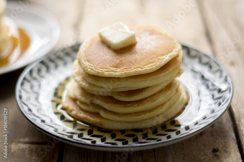 Homemade pancakes on the black and white plate on the wooden table