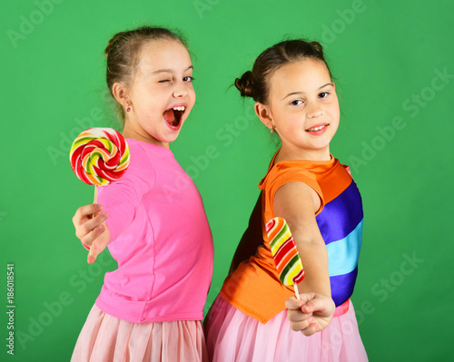 Sisters with round and long shaped lollipops