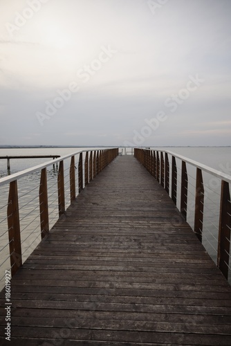 Wooden walk on Lesina lake in a cloudy and foggy day (backdrop)