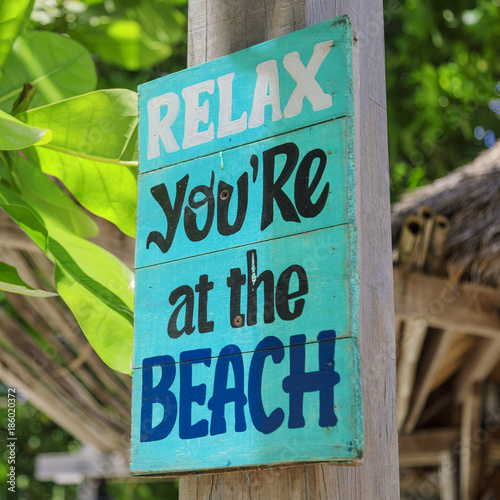 Relax, you're at the beach - wooden sign