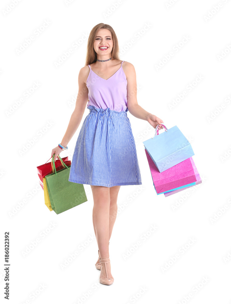Happy young woman with shopping bags on white background Happy young woman with shopping bags on white background