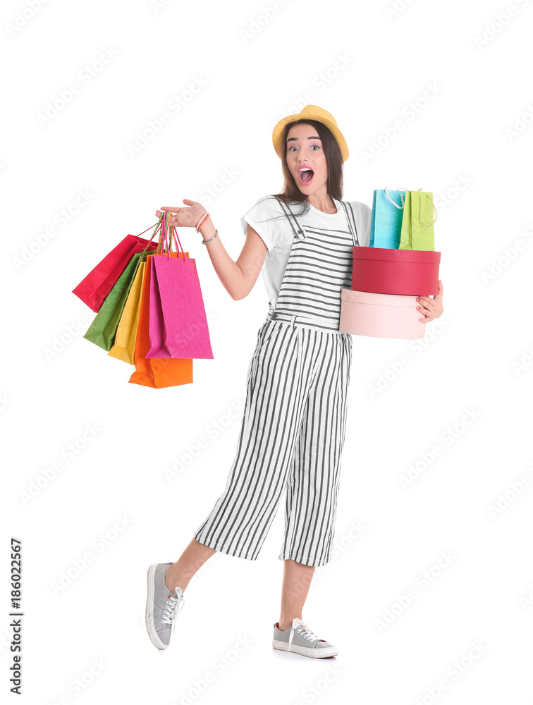 Excited young woman with shopping bags and boxes on white background Excited young woman with shopping bags and boxes on white background