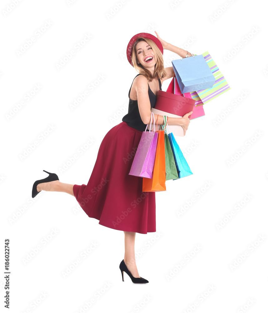 Happy young woman with shopping bags and boxes on white background