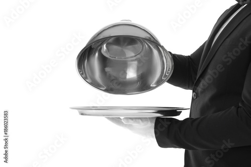 Waiter with metal tray and cloche on white background photo