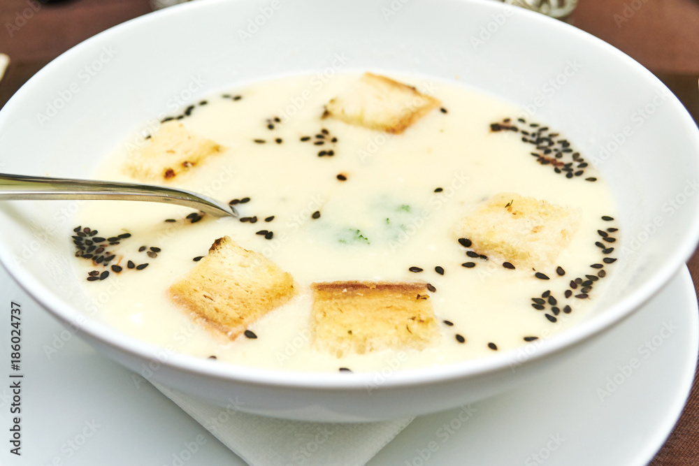 Delicious cream soup with bread on table Delicious cream soup with bread on table